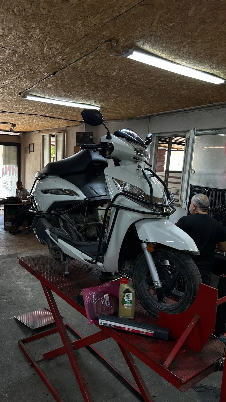 Crash bars being fitted to a scooter at Kral Motor
